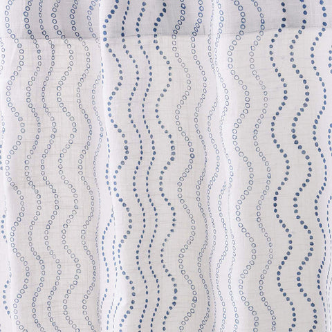 Close-up of cotton slub curtain fabric featuring a blue wave hand block printed design.