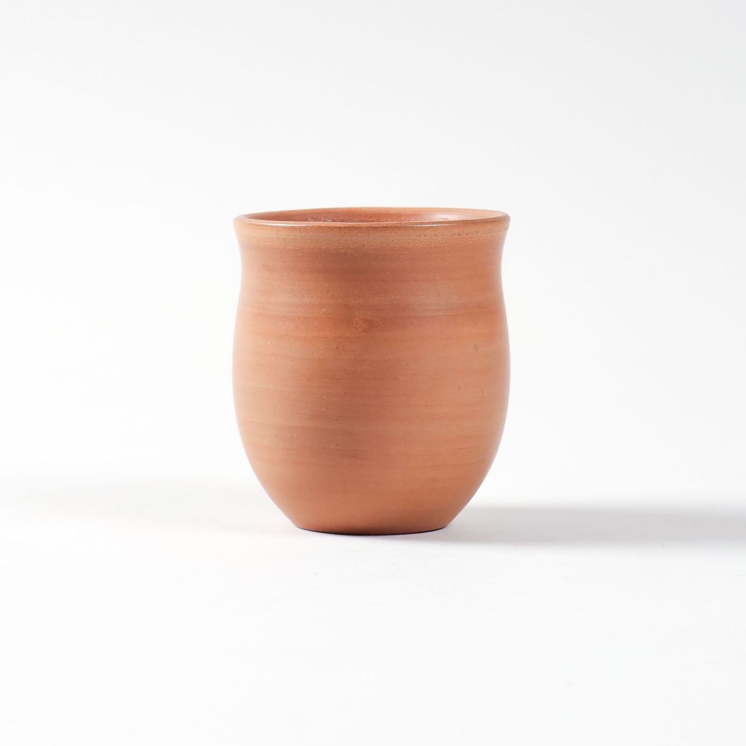 Eye-level view of the curved terracotta kulhad cup handcrafted in India.