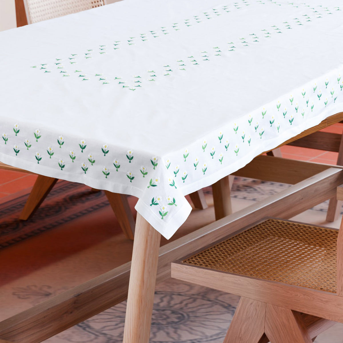 Daisies embroidered cutwork tablecloth styled on a dining table creating an elegant and handcrafted dining setting