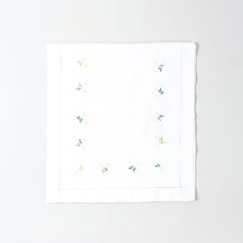 Folded white cotton table runner showcasing delicate daisy embroidery and handcrafted Bengal chikankari detailing