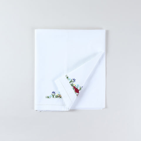 Cotton kids bedsheet folded back diagonally to showcase both colourful duck embroidery styles with Bengal Chikankari hand embroidery on white fabric