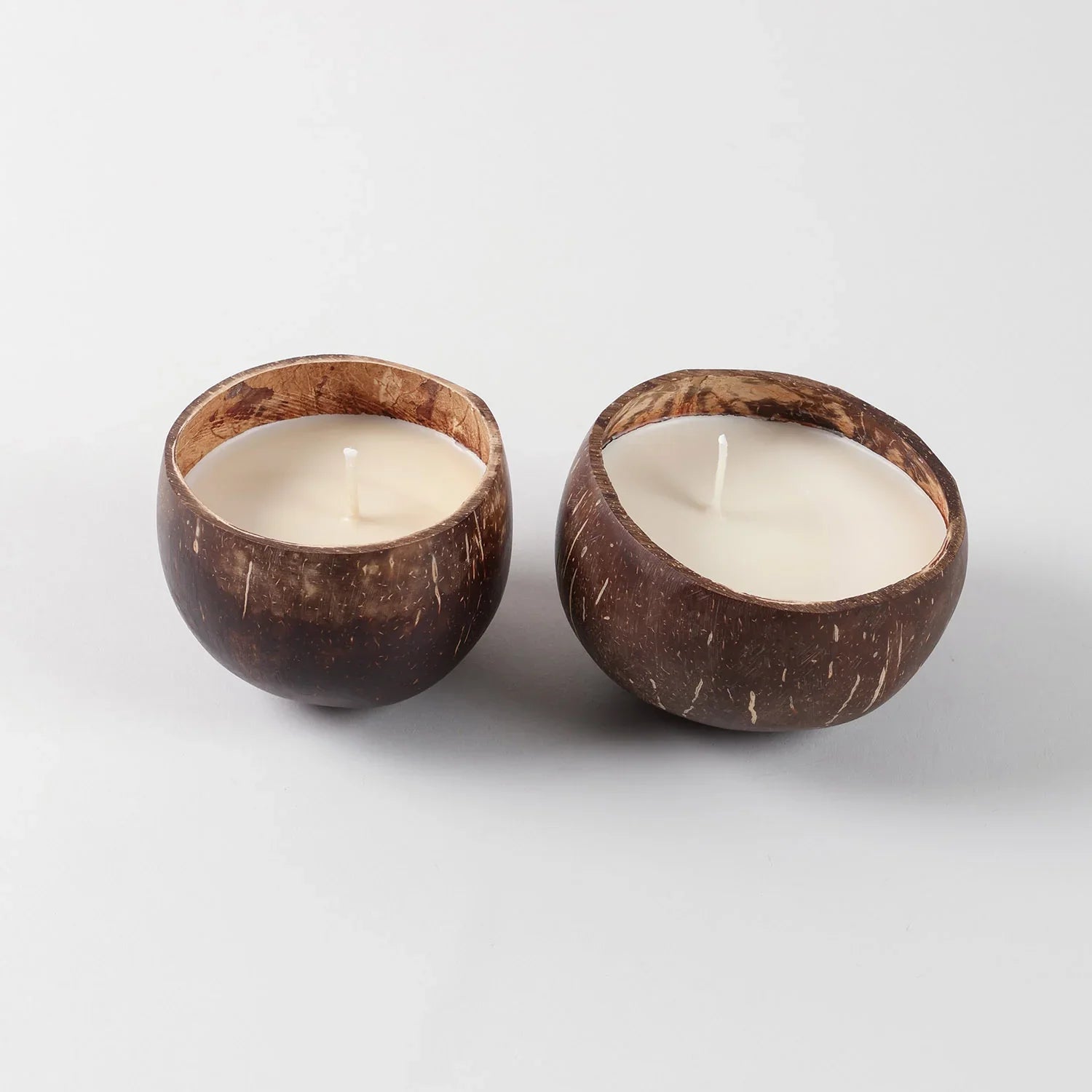 Sustainable coconut shell soy wax candle showcasing eco-friendly craftsmanship and natural materials