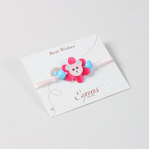 Angled view of the Eco-friednly Wooden Teddy Bear Kids Rakhi Set of 2 in Blue Pink attached to a festive Best Wishes card for Raksha Bandhan gifting