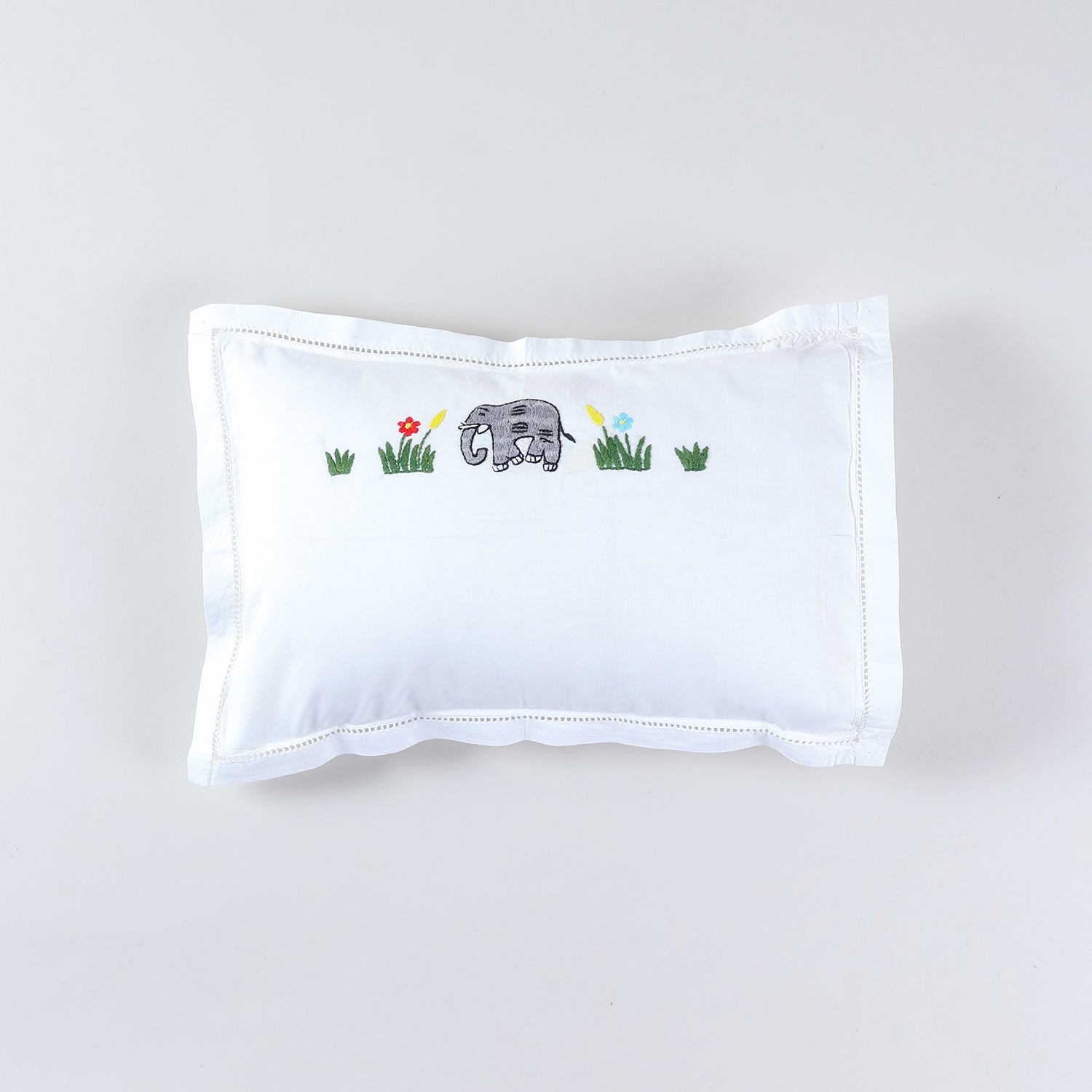 Kids pillow cover with colourful elephant hand embroidery on a white cotton base from the handmade kids bedding collection