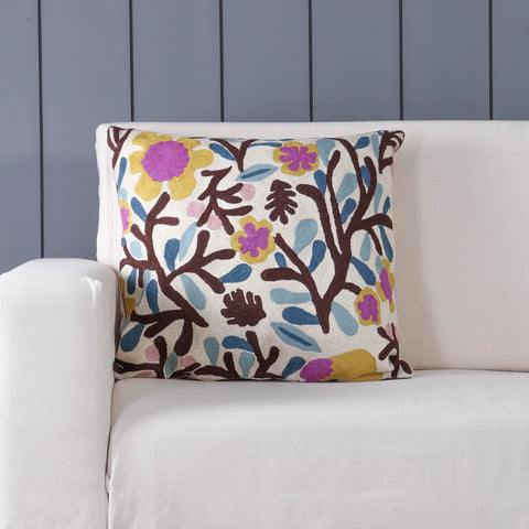 Floral tree hand embroidered crewel cushion cover styled on a sofa adding heritage charm to living room decor