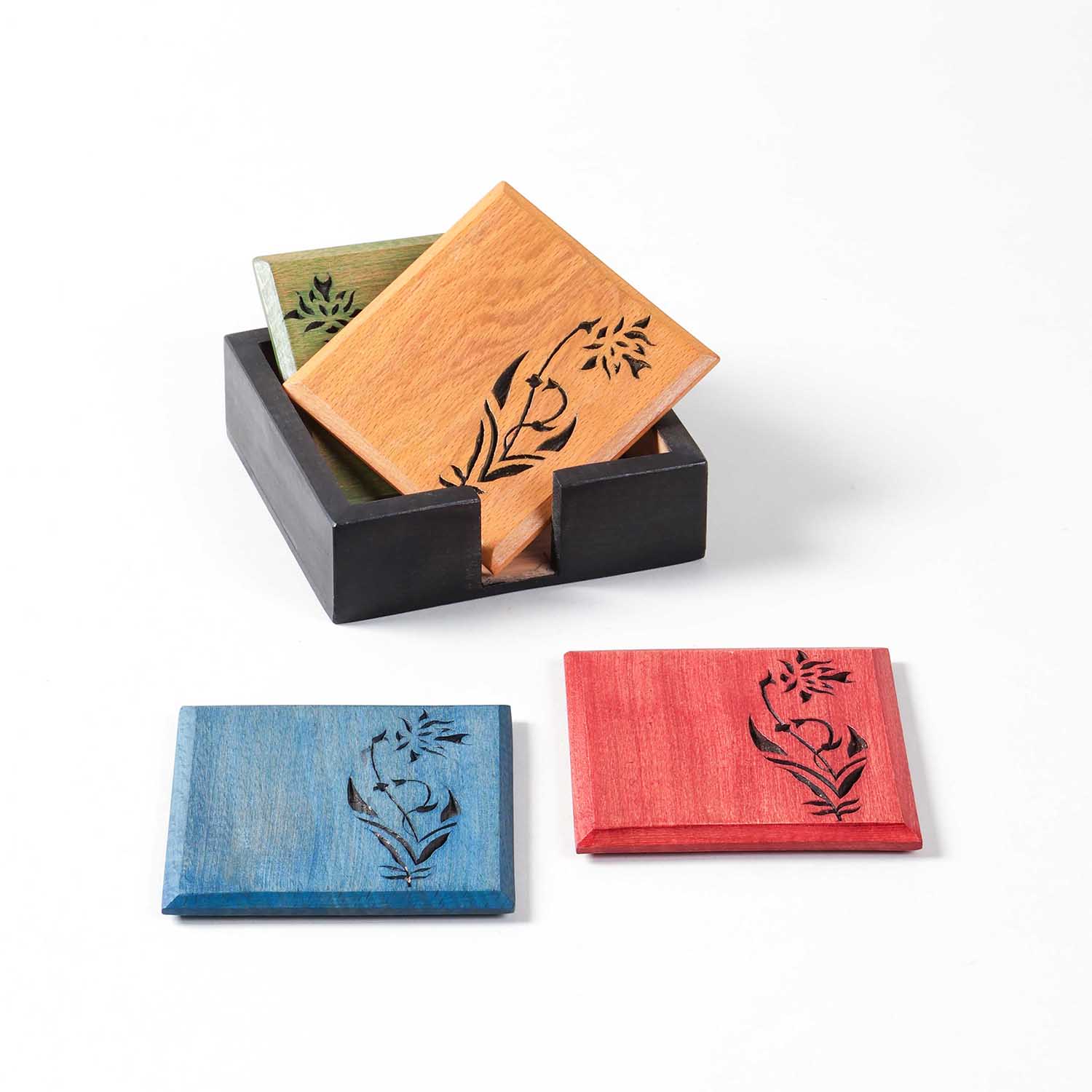 Front view of the Floral Vine handcarved wooden coaster set with two coasters in the holder and two stacked outside