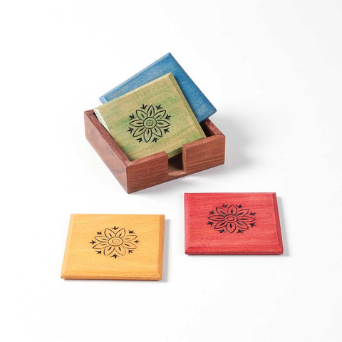Front view of the Floral wooden coaster set with two coasters in the holder and two stacked outside