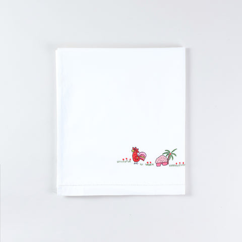 Neatly folded handmade cotton kids bed linen with Bengal Chikankari duck embroidery from the kids collection