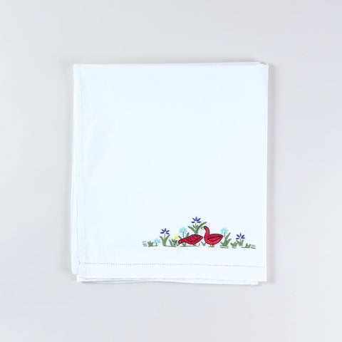 Neatly folded handmade cotton kids bed linen with Bengal Chikankari duck embroidery from the kids collection