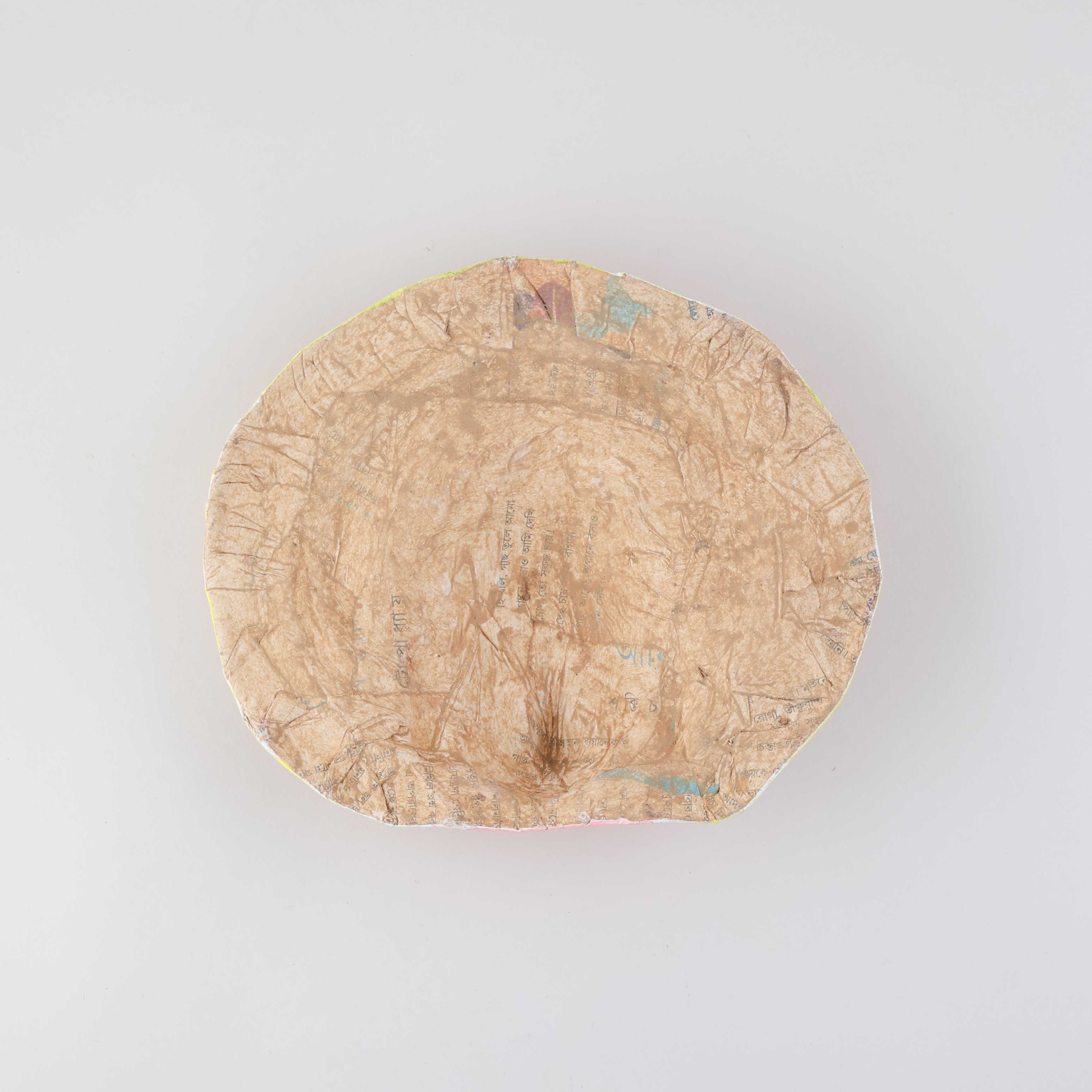 Back view of a handmade Ganesha Chhau wall mask showing the handcrafted clay, cloth, and paper construction with hanging support