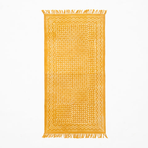 Handwoven floor runner with geometric motifs and fringe detailing