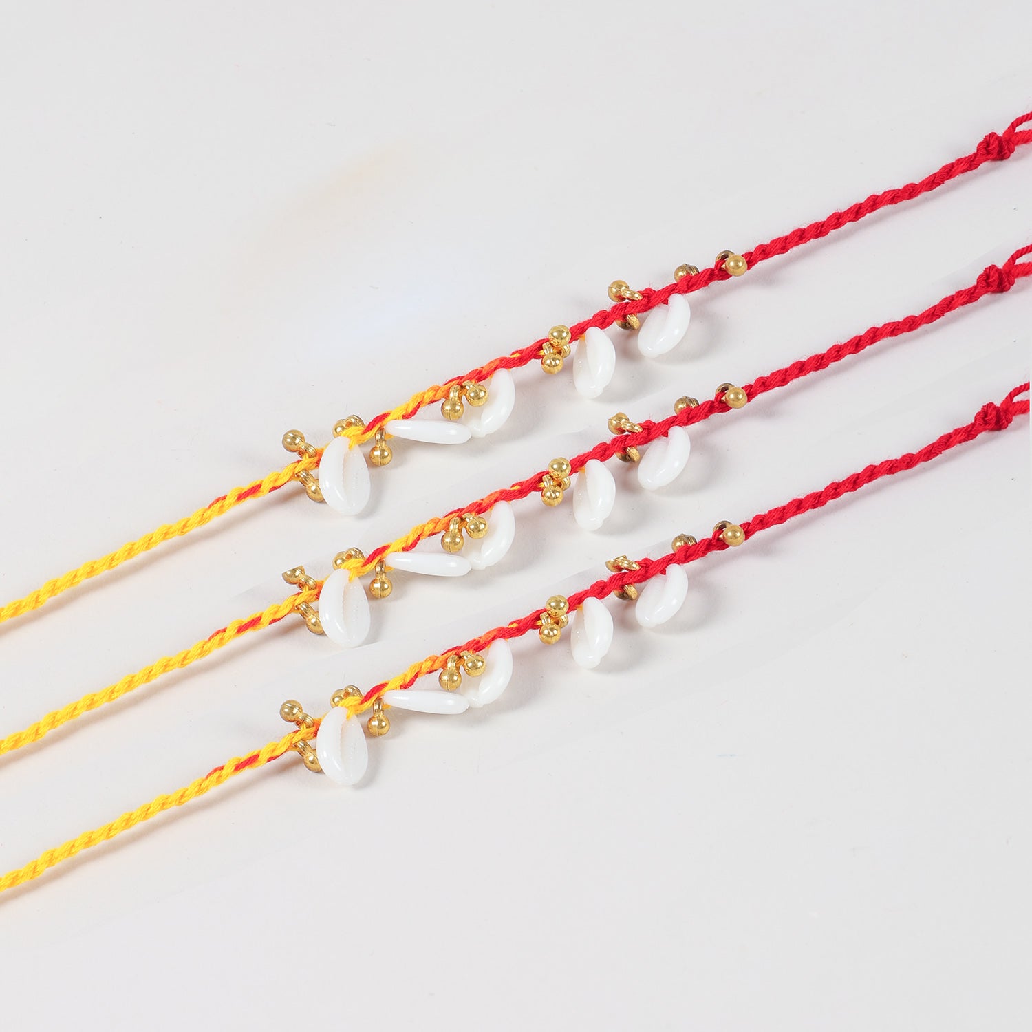 Close up view of handmade sea shells and ghungroo rakhi design for Raksha Bandhan