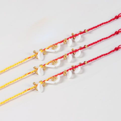 Close up view of handmade sea shells and ghungroo rakhi design for Raksha Bandhan