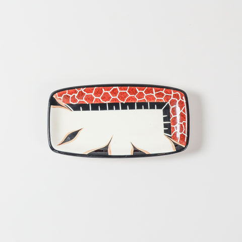 Top view of a handmade ceramic platter featuring a giraffe illustration and decorative African-inspired patterns on a glossy surface
