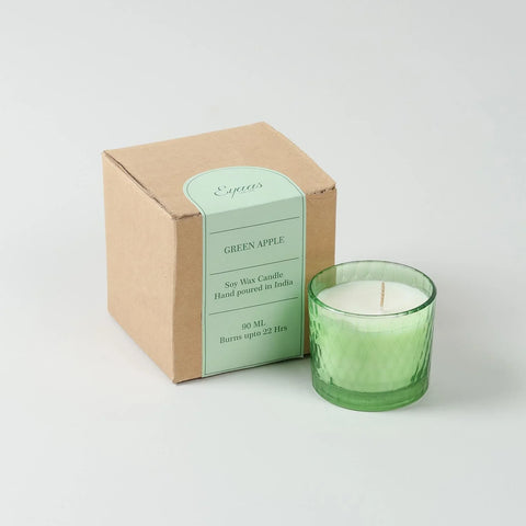 Green Apple scented soy wax candle in a decorative glass holder displayed alongside a gift