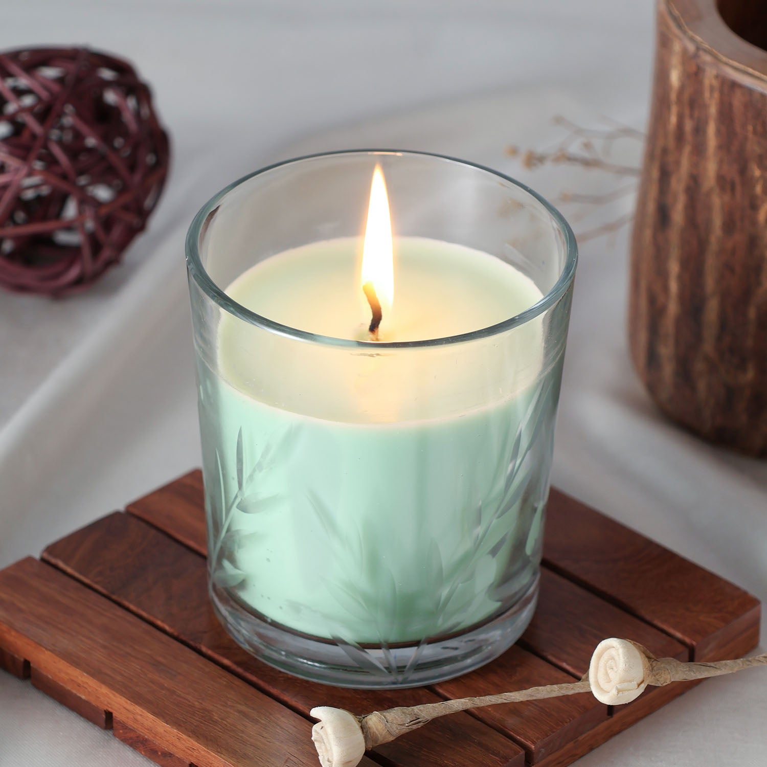 Green apple scented soy wax candle in a decorative green glass jar, styled and lit for fresh home decor