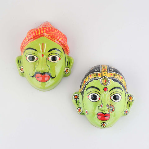 Hand-painted green Cheriyal couple mask set crafted from papier-mache, featuring traditional folk art details on a plain background