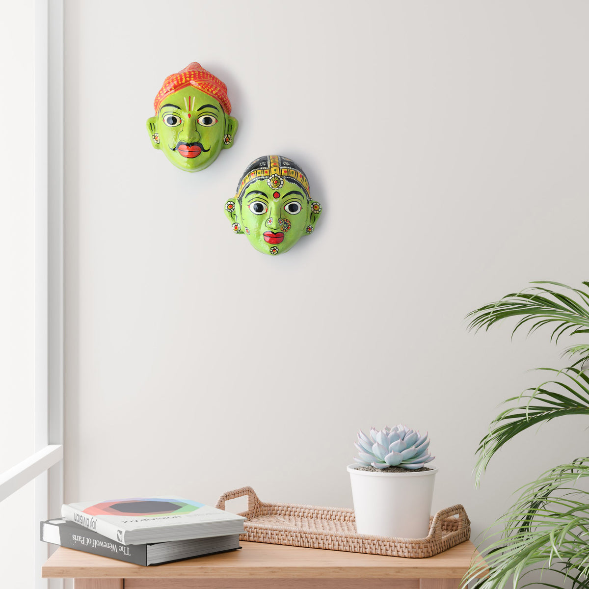 Handcrafted Cheriyal couple mask set displayed as wall decor, showcasing traditional Telangana folk art and hand-painted papier-mache craftsmanship
