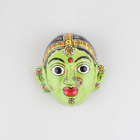 Hand-painted green Cheriyal female mask crafted from papier-mache, featuring intricate folk art detailing and traditional craftsmanship on a plain background