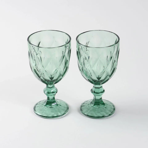 Front view of two green diamond-pattern wine glasses placed side by side showcasing handcrafted texture and elegant design