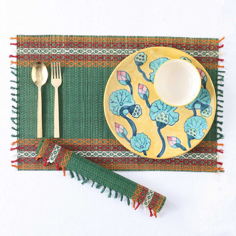 Flat lay of green Madhurkathi placemats, and dining accessories showcasing eco-friendly dining table mats