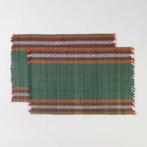 Handwoven green Madhurkathi placemat set crafted from natural river grass with red, white, and orange border accents
