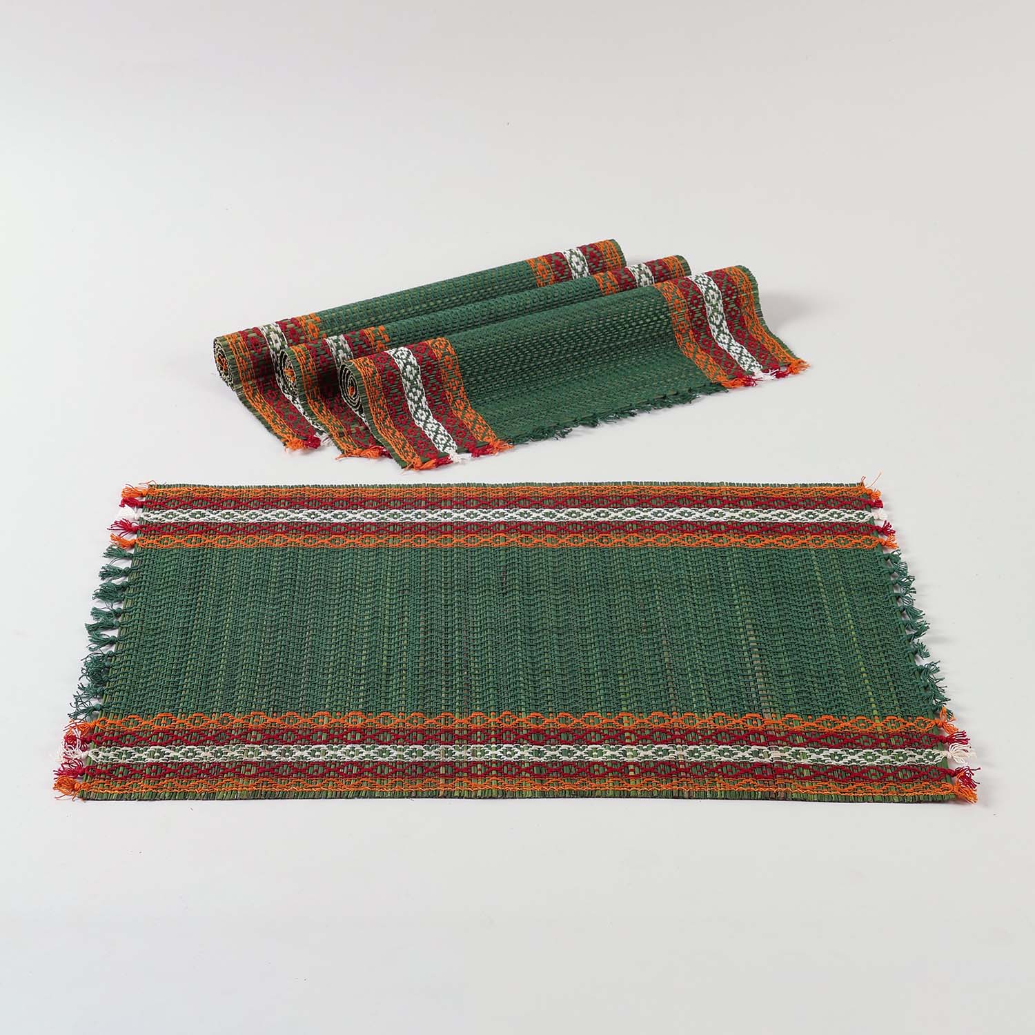 Green natural fibre placemats crafted from Madurkathi grass, displayed as a dining table mat set of 4 with a handwoven texture