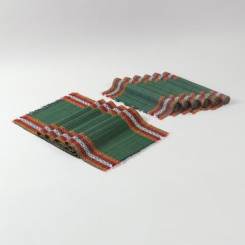 Handmade green table runner and placemats set crafted from Madurkathi grass, showcasing natural fibre texture and colourful woven borders
