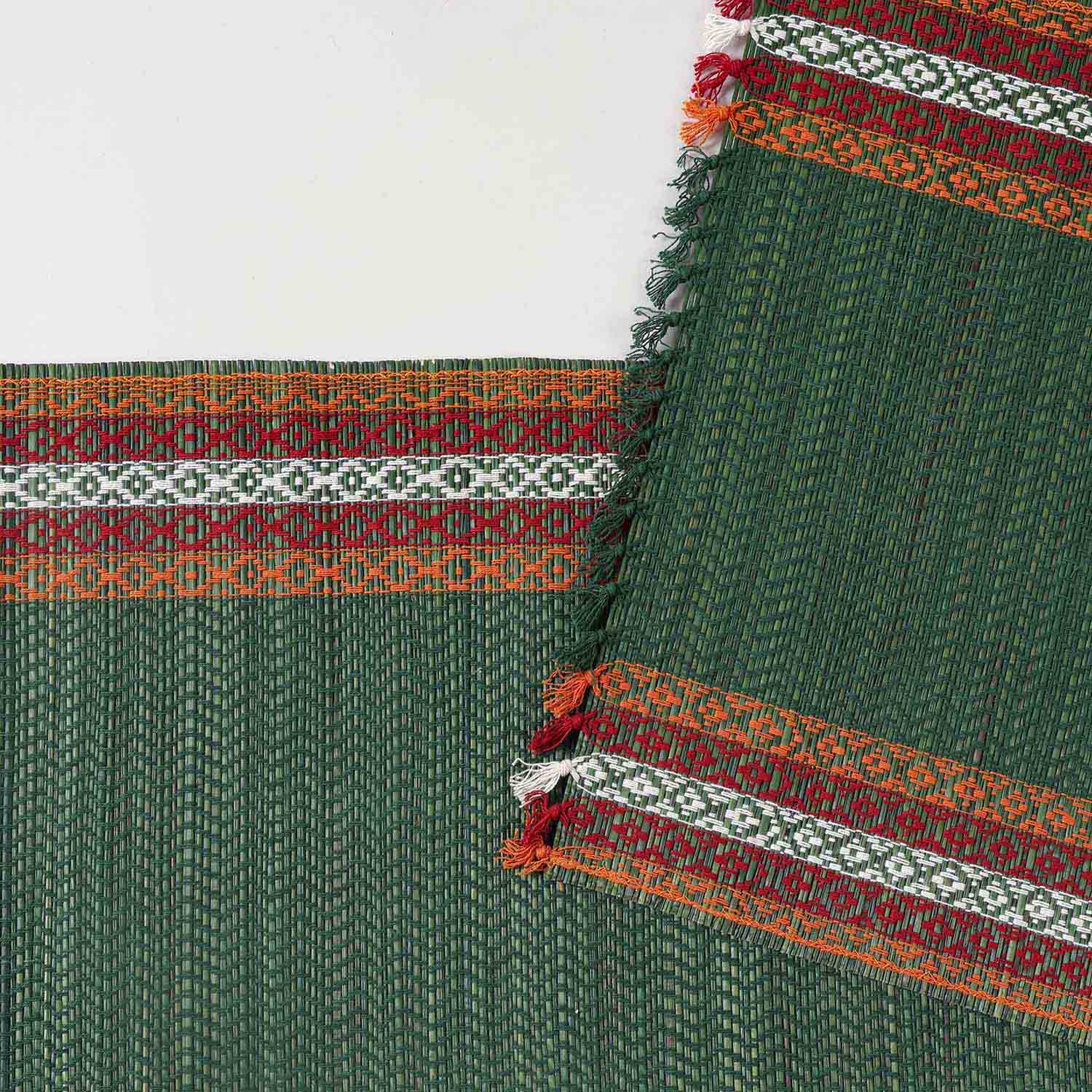 Detailed close-up of a green Madurkathi table runner showcasing dense natural fibre weaving and handcrafted texture