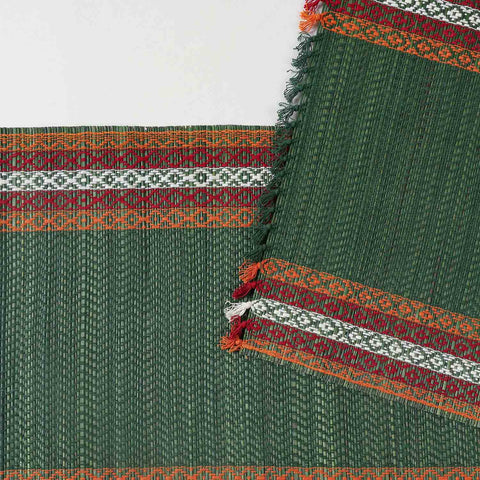 Close-up of a green Madurkathi table runner featuring intricate handwoven patterns, natural fibre texture, and detailed border accents