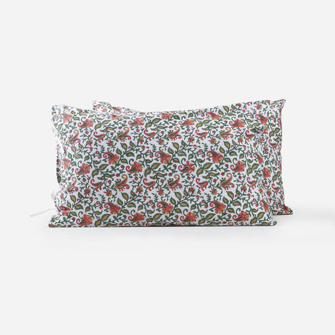 Set of two hand block printed cotton pillow covers with green, pink, and mustard paisley jaal pattern on a white background