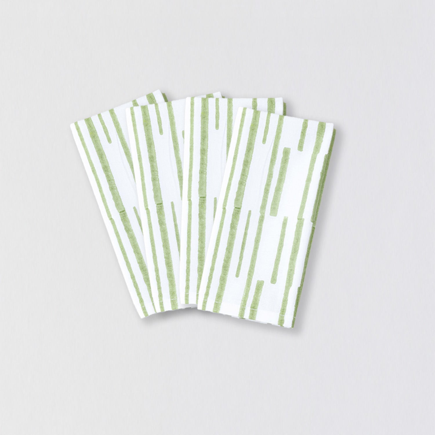 Set of four cotton dining table napkins with handcrafted green stripe pattern and everyday functionality