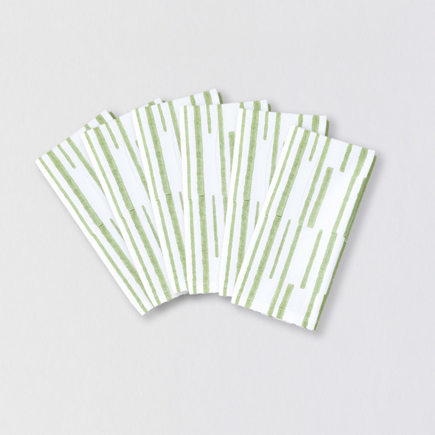 Pack of six reusable cotton napkins with green linear block print for family meals and gatherings