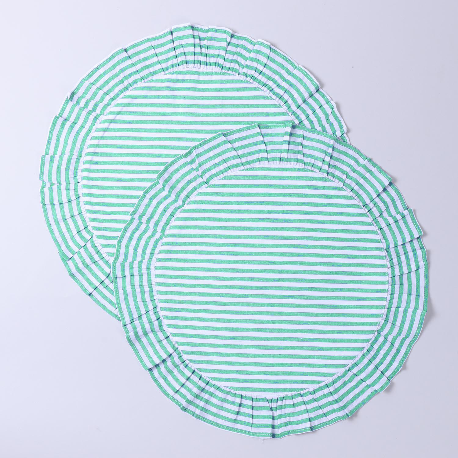Pair of round cotton placemats featuring green stripes and decorative frilled edges displayed on a plain background
