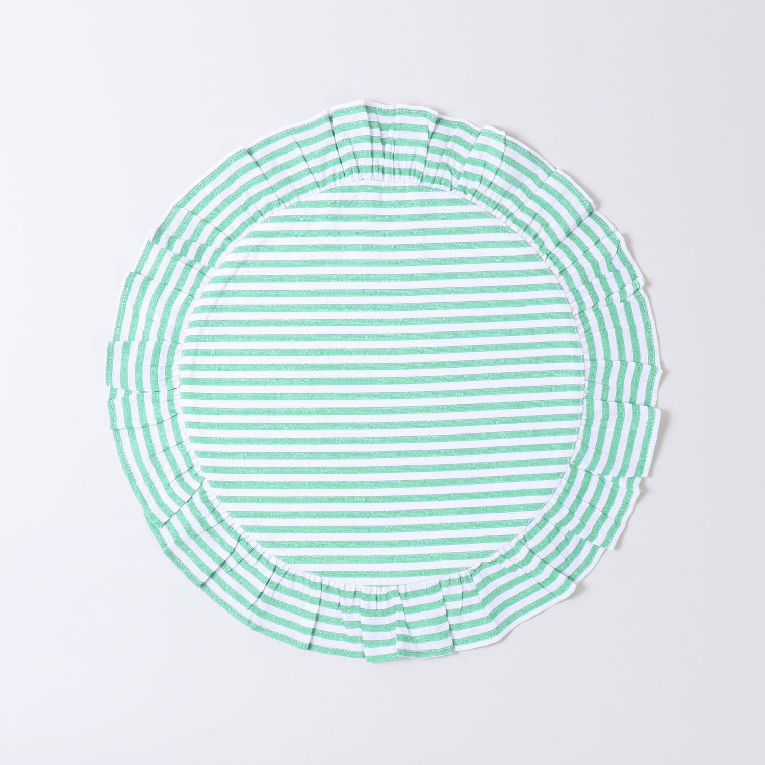 Round cotton placemat with green stripe patterns and soft frilled border on a white base