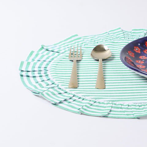 Handmade round cotton placemat with green stripes arranged with dinnerware on a dining table creating an elegant dining table décor setup