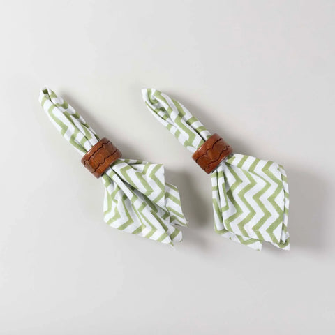 Set of 2 green and white zigzag block printed cotton napkins styled with napkin holders for dining table decor and everyday use