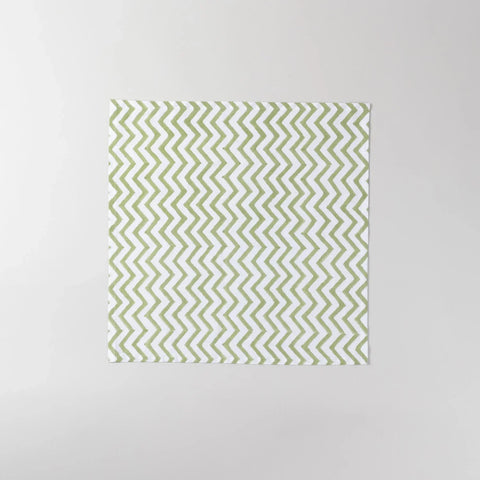 Full-size green and white zigzag block printed cotton napkin measuring 18 x 18 inches