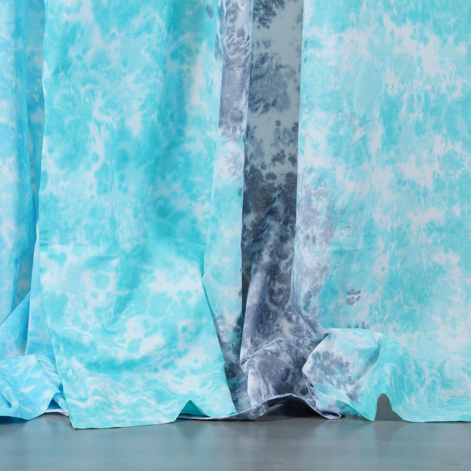 Close-up of the handcrafted grey and blue tie-dye pattern on soft mulmul cotton curtain fabric