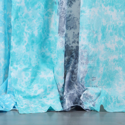 Close-up of the handcrafted grey and blue tie-dye pattern on soft mulmul cotton curtain fabric