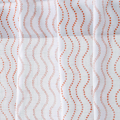 Close-up of grey cotton slub curtain fabric with a hand block printed brown wave design