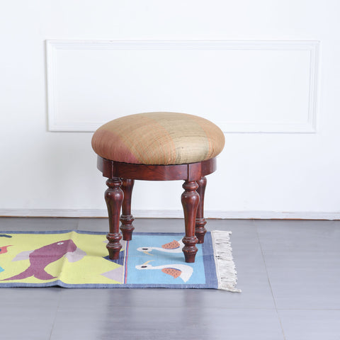 Handwoven cotton dhurrie with duck and fish motifs styled in a hallway, adding colour and artisan charm