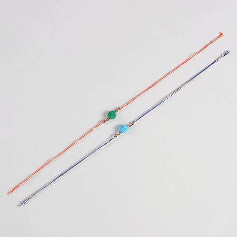 Full-length view of the Handmade Crochet Bead Rakhi showing the complete dual-colour cotton threads and handcrafted crochet bead design