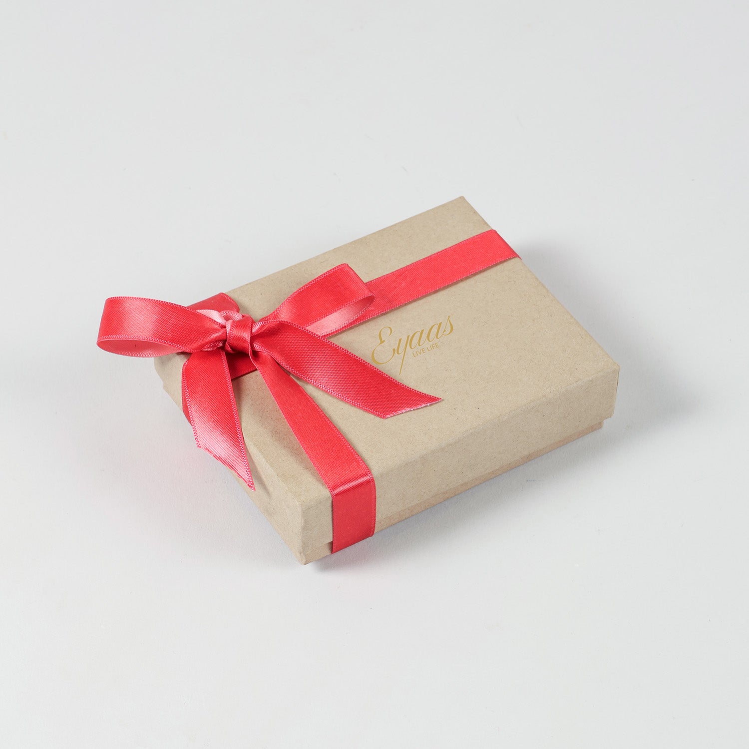 Gift-ready Handmade Crochet Brass Bead Rakhi beautifully packed in elegant festive packaging with a decorative ribbon