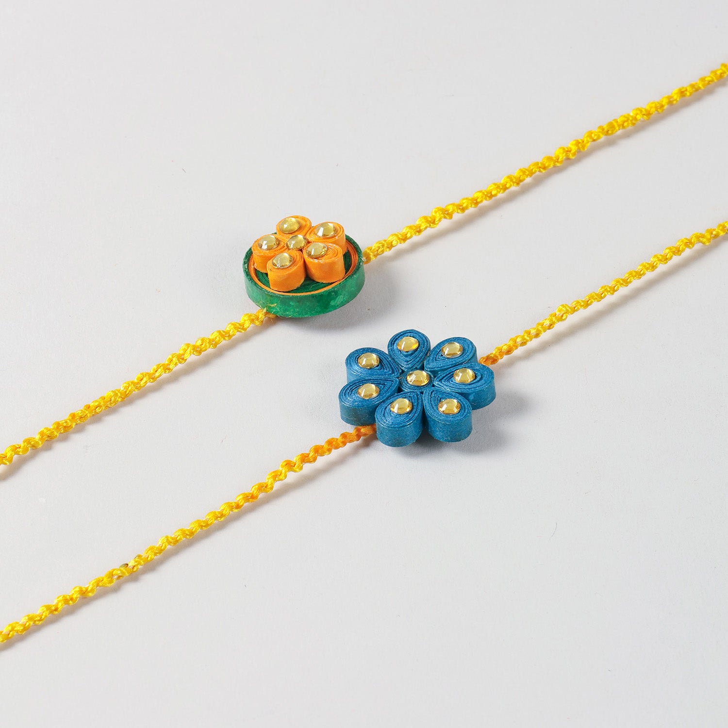Close-up of the Handmade Floral Paper Quilled Rakhi showcasing intricate hand-quilled floral details and colourful paper craftsmanship