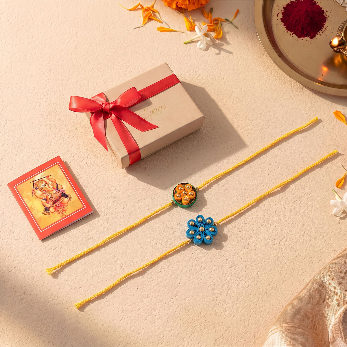 Handmade Floral Paper Quilled Rakhi beautifully presented in a festive gift box with ribbon, ready for Raksha Bandhan gifting