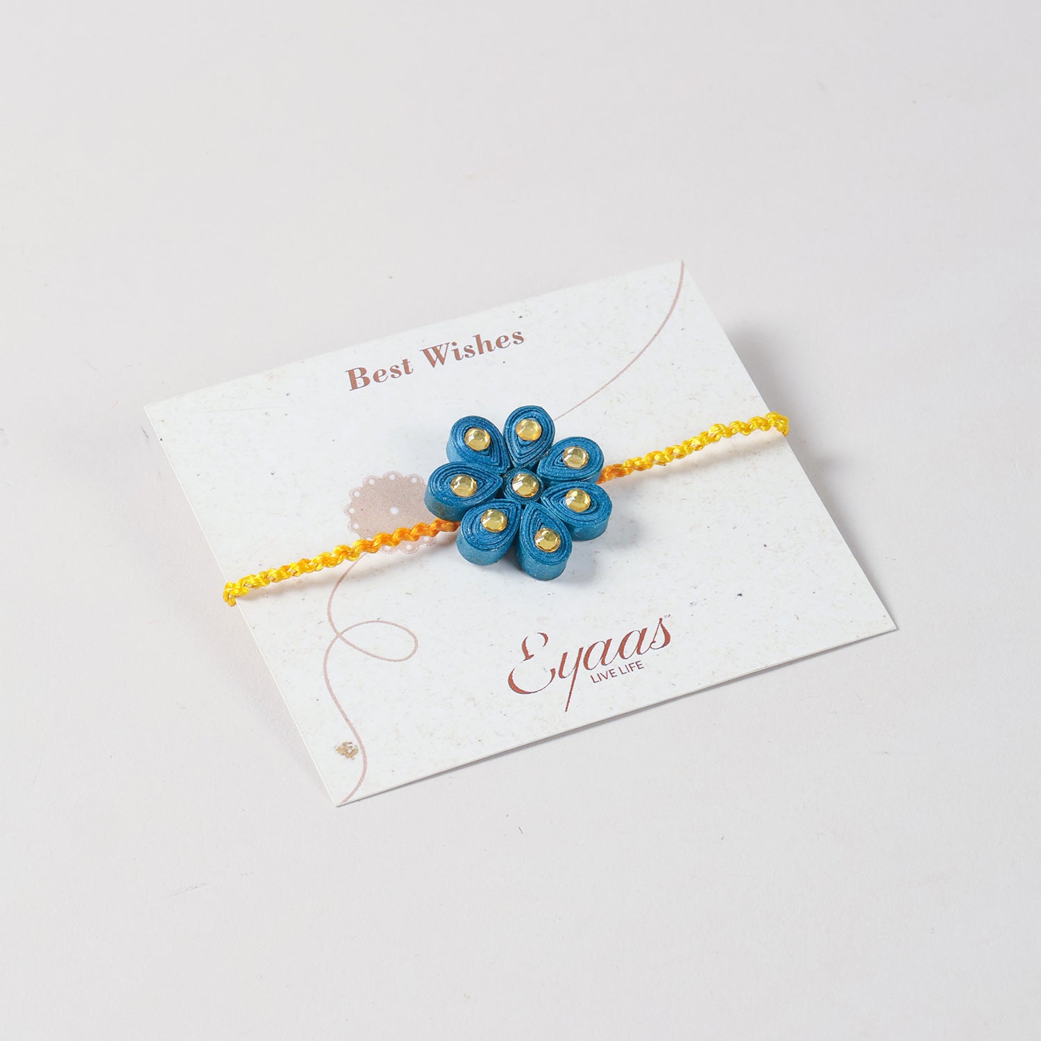 Handmade Floral Paper Quilled Rakhi  attached to a festive Best Wishes card for Raksha Bandhan gifting.