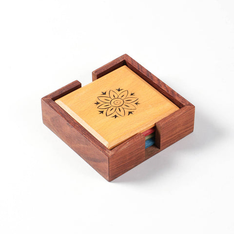 Handmade floral wooden coaster set crafted in India for stylish table protection.