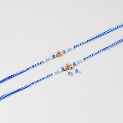 Close-up of the Handmade Ganesh Rakhi & Lumba Set featuring the Ganesh charm, blue beads, and handcrafted detailing.