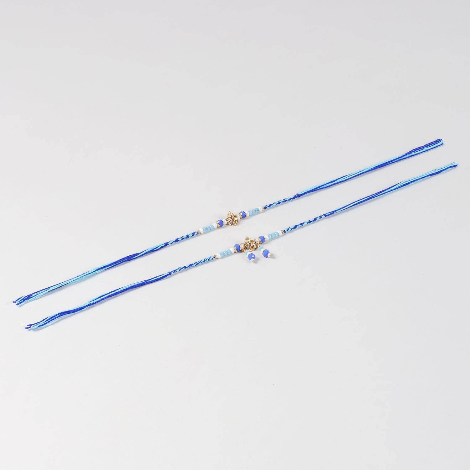 Full-length view of the Handmade Ganesh Rakhi & Lumba Set with Blue Beads for Bhaiya Bhabhi, showcasing the complete rakhi, lumba and handcrafted design